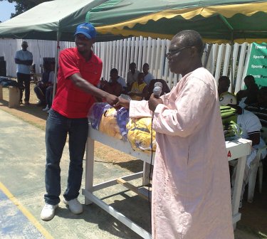 CEO of Hoops receiving jersey from MP of NKwanta South